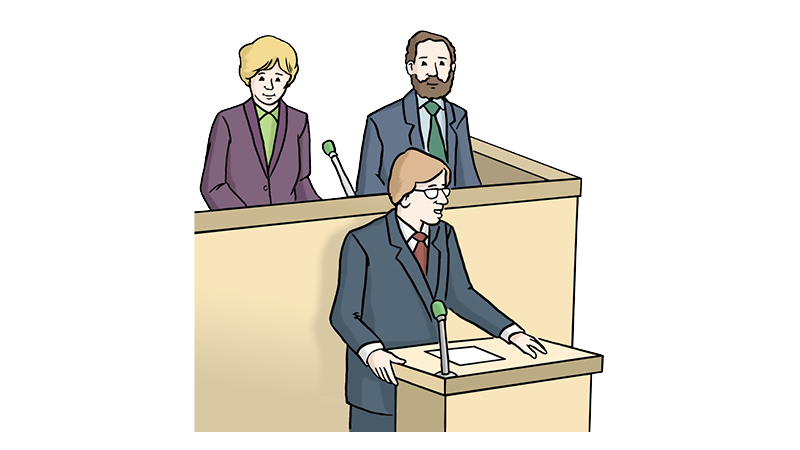 Die Illustration zeigt eine Person (männlich dargestellt). Diese steht an einem Rednerpult mit Mikrofon, vor der Person liegen Papiere. Im Hintergrund stehen zwei weitere Personen (eine Frau mit blondem Haar und ein Mann mit Bart) Sie stehen hinter einer erhöhten Trennwand, ebenfalls vor Mikrofonen. 